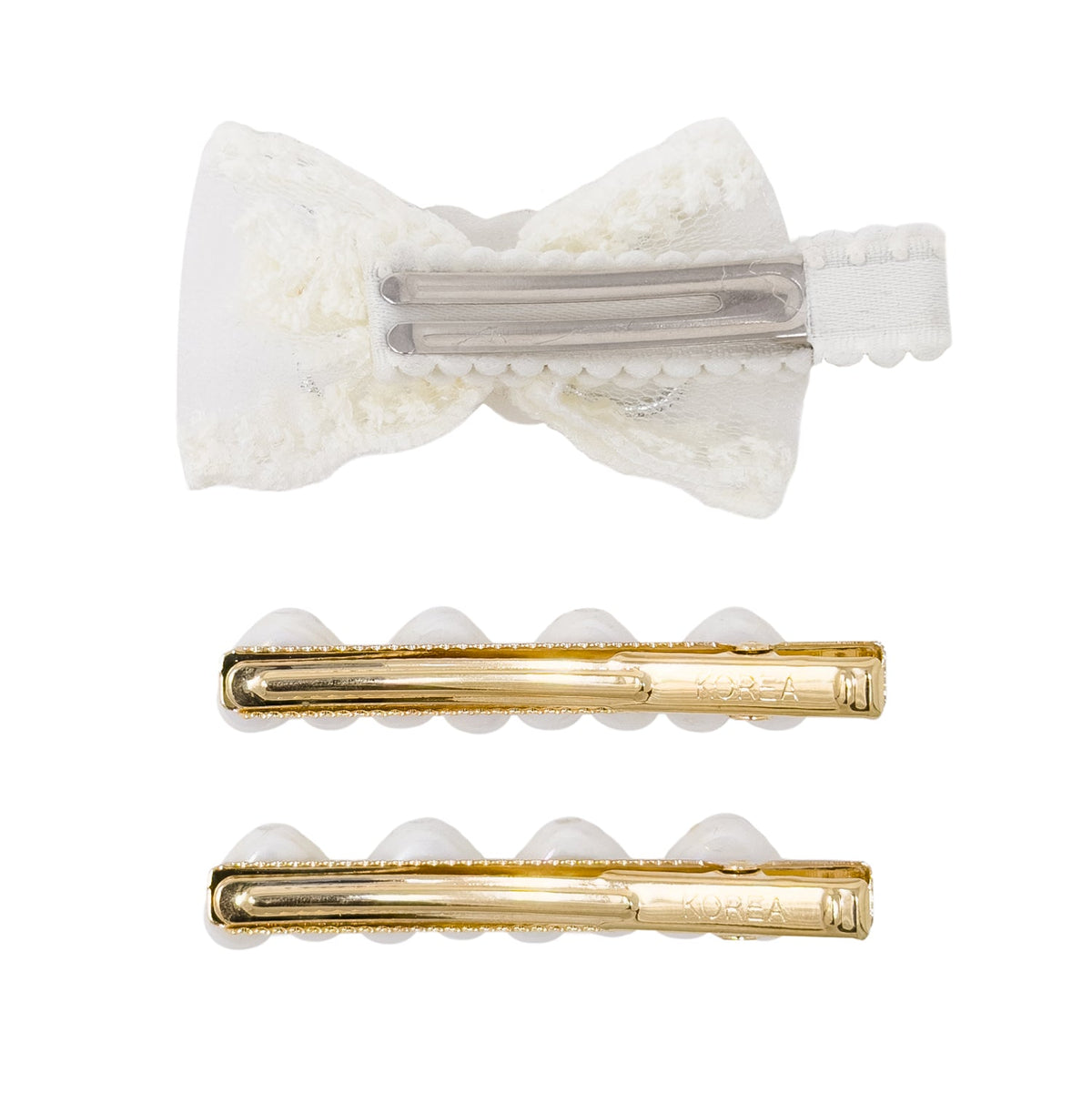 Three hair clips on a plain white background: a white lace bow-shaped clip at the top and two slim gold-toned bar clips below.