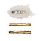 Three hair clips shown on a plain white background: one cream lace hair clip with a silver metal clip, and two gold metal hair clips with pearl-like accents.