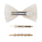 A hair accessory set on a white background, featuring a cream lace hair bow with a silver metal clip, and two gold-toned bar pins decorated with white pearl-like beads.