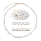 A pearl hair accessory set on a white background, including a pearl strand necklace with a gold chain, a white lace and satin bow hair clip, and two gold heart-bar hair clips.