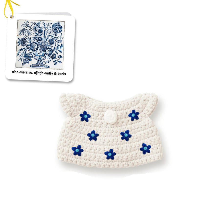 Crocheted off-white purse with blue flower detailing.