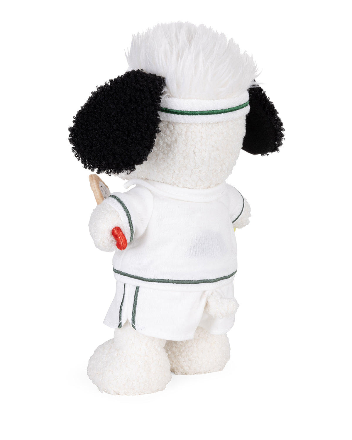 Stuffed poodle toy in tennis outfit, holding a racket.