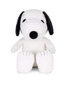White plush dog toy with black accents on a white background