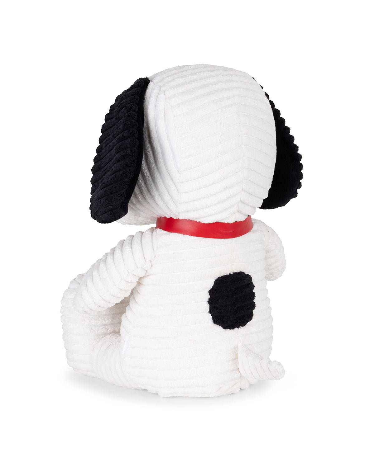 White dog-shaped plush toy with black ears and spots on a white background