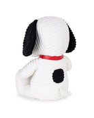 White dog-shaped plush toy with black ears and spots on a white background