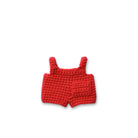 Red crocheted overalls with straps and a pocket.
