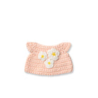 Crocheted pink hat with white and yellow flowers.