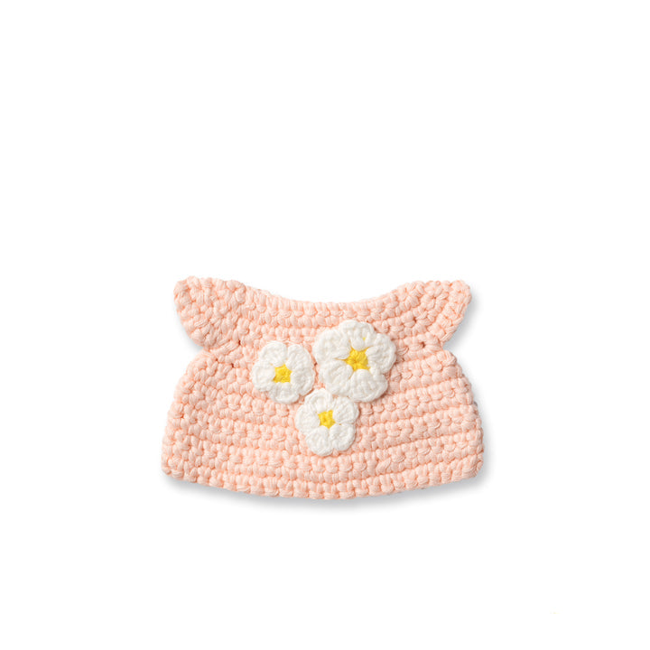 Crocheted pink hat with white and yellow flowers.