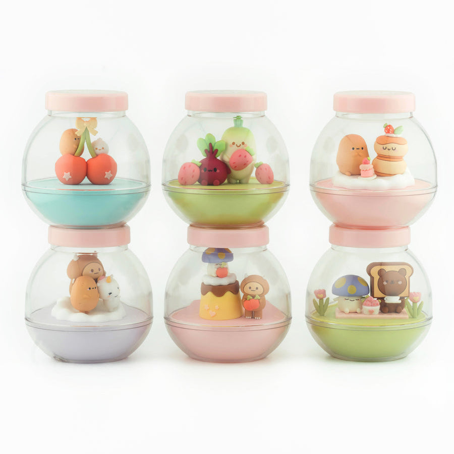 Set of four small glass jars with colorful contents on a white background