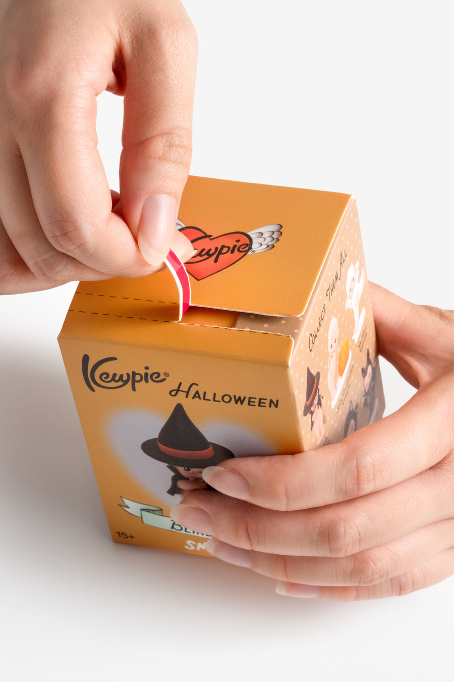Kewpie Halloween-themed product packaging with a hand interacting with it on a white background