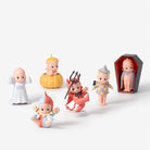 Set of small figurines in various costumes on a white background