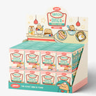A retail display box filled with small Taito's Diner-themed product boxes, photographed on a clean white studio background. The display features pastel colors, cartoon diner illustrations, and the Taito logo.
