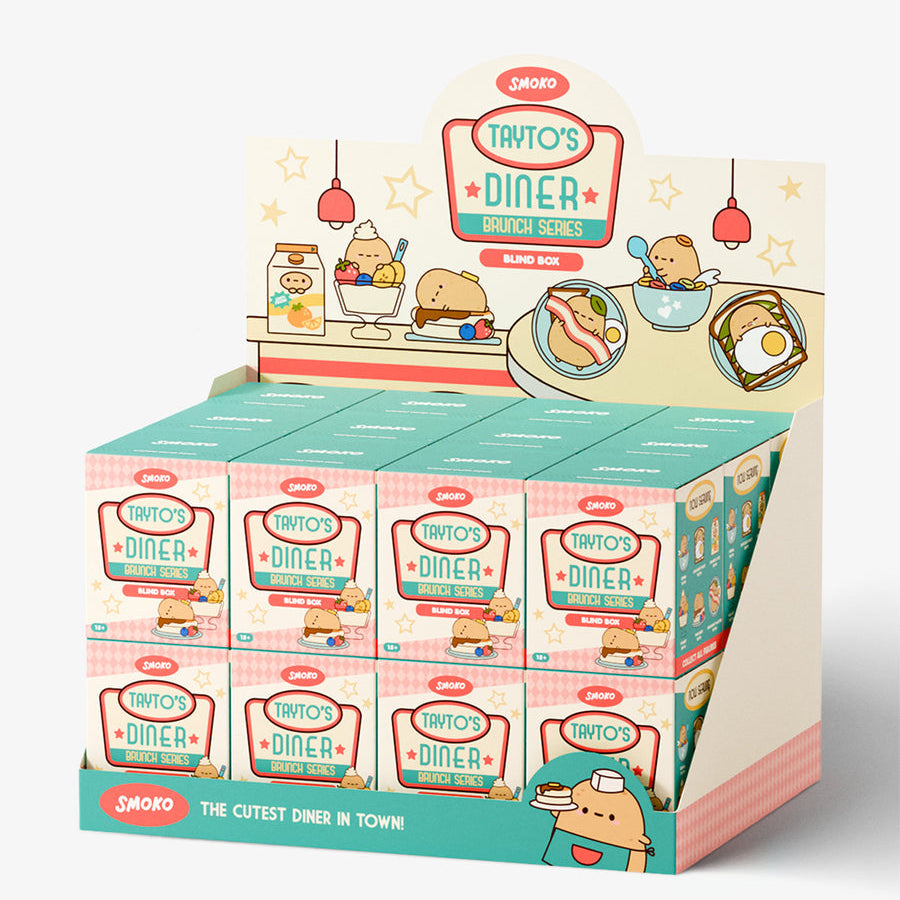 A retail display box filled with small Taito's Diner-themed product boxes, photographed on a clean white studio background. The display features pastel colors, cartoon diner illustrations, and the Taito logo.