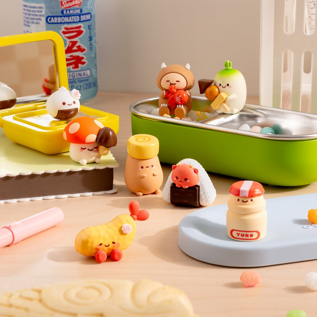 Set of small animal figurines on a table with a bottle in the background