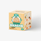 A cube-shaped box of Soko Snacks featuring a cute cartoon character wearing a green hat on the front, with various snack illustrations on the side panels, set against a plain light gray background.