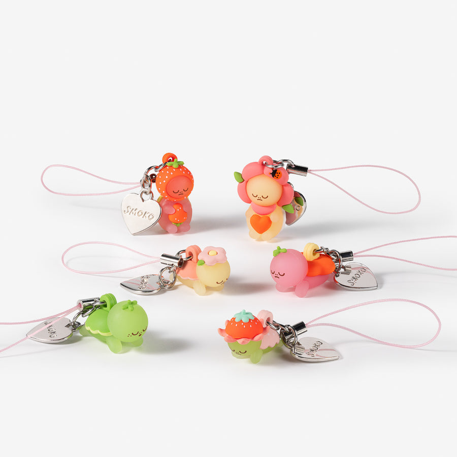 Six small pastel character charms attached to pink cords and silver metal clips, arranged on a clean white background.