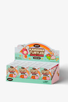A retail display box filled with small 'Kawawa Turtles Phone Charm' blind box packs by Zoro, featuring colorful cartoon turtle graphics on a light gray background.