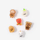Six small cartoon character charms or pins in assorted colors, including brown, orange, yellow, white, and green, arranged on a plain light background. Each character has the word 'SMOKO' printed on it.