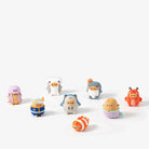 Set of small colorful figurines on a white background