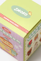 Smoko product packaging with cartoon illustrations on a light green background