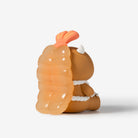 A small orange and brown cartoon figurine shown from the back on a clean white background.