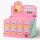 A pink SMORO Tayto Potato Blind Box display stand filled with individual mystery boxes. The packaging features a cute cartoon potato character on a pink background with the text 'TAYTO POTATO BLIND BOX' and 'SMORO' printed on the boxes.