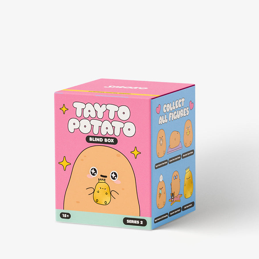 A pink and blue mystery box for a 'Tayto Potato Blind Book' collectible, featuring cute cartoon potato graphics, shown on a clean white background.