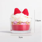 Glass dessert with layers of pink, white, and red on a white background