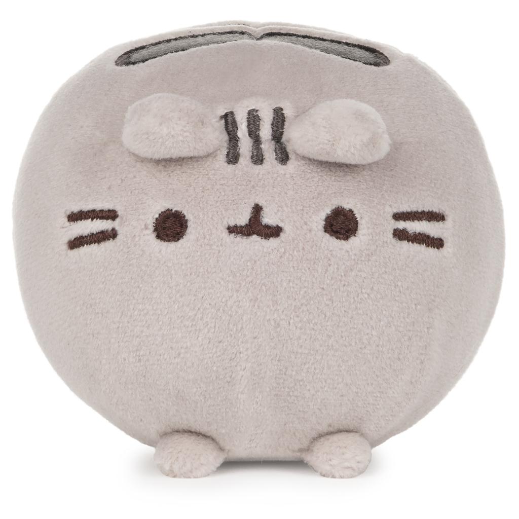 Mocha round plush toy with a simple face design on a white background