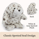 White and gray spotted plush seal toy with back view on a beige background