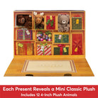 A wooden advent-style gift box with multiple compartments displaying plush animals and wrapped presents, shown open on a white background with a red text banner at the bottom.