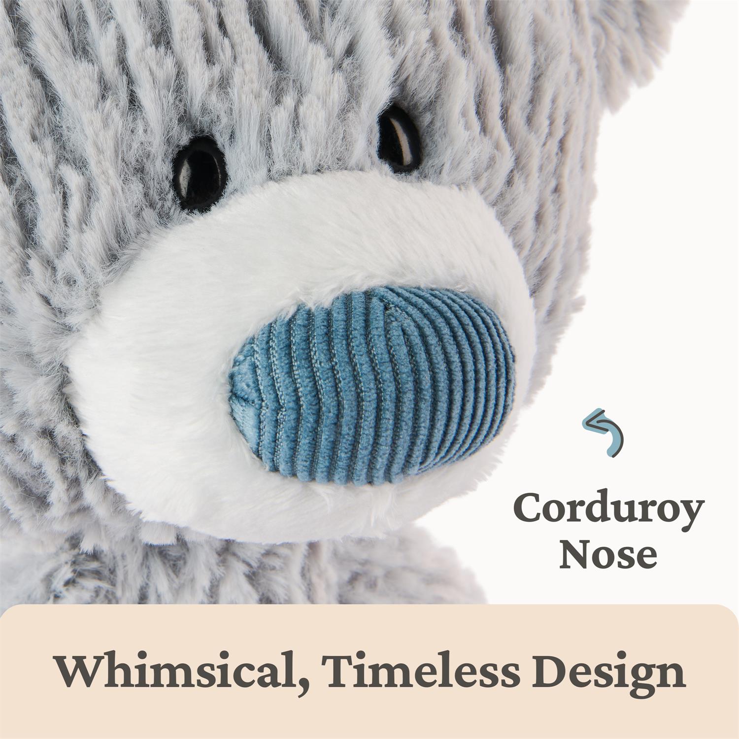 Plush bear with a blue corduroy nose on a white background