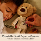 Person lying down with a teddy bear wearing a Pointelle-Knit Pajama Onesie, with text about the onesie's features.