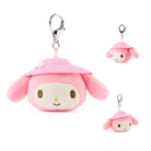 Pink plush character with a small attached plush toy on a white background