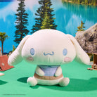Plush toy with a cartoonish design sitting on a green surface with a scenic background.