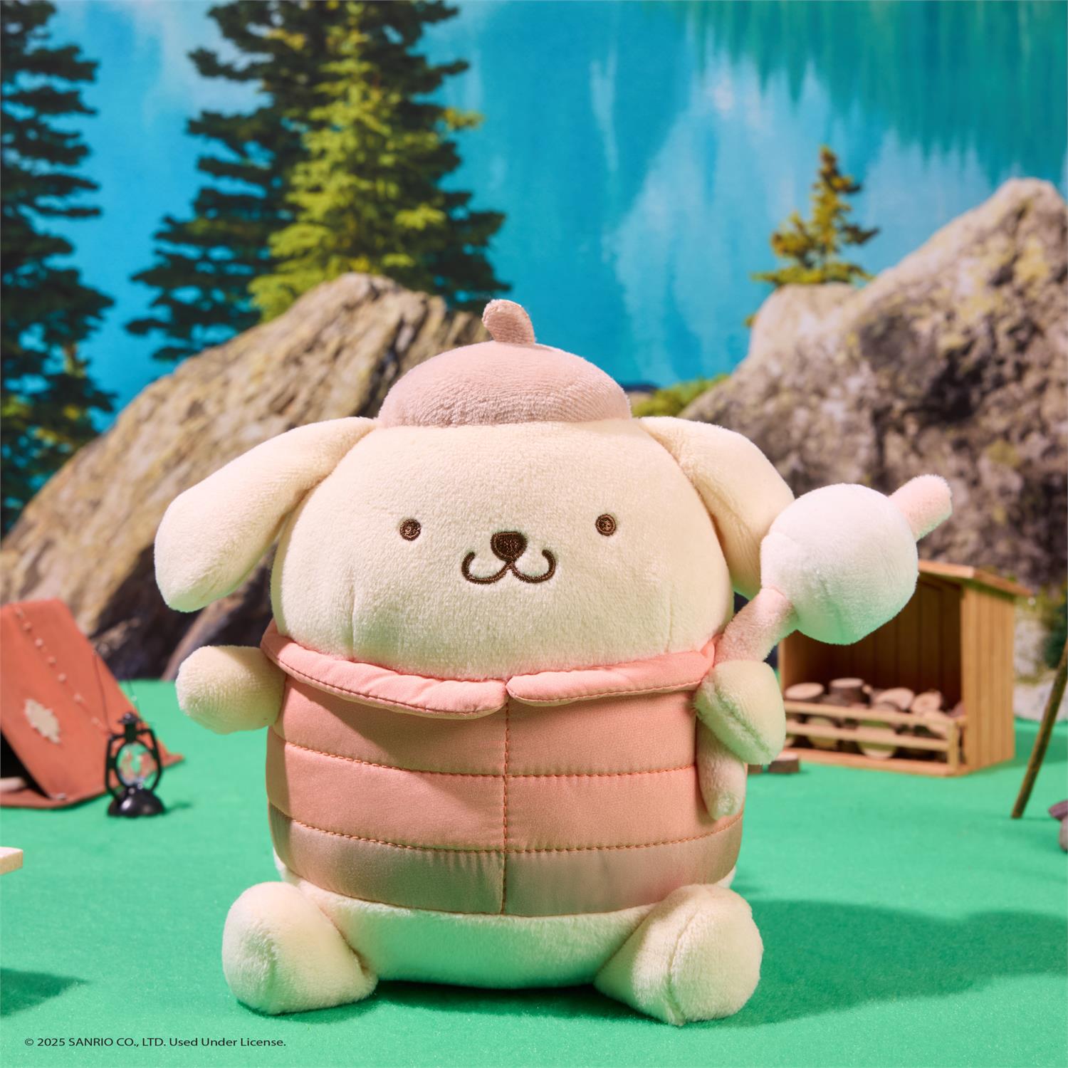Plush toy resembling a character with a pink hat and scarf in a forest setting