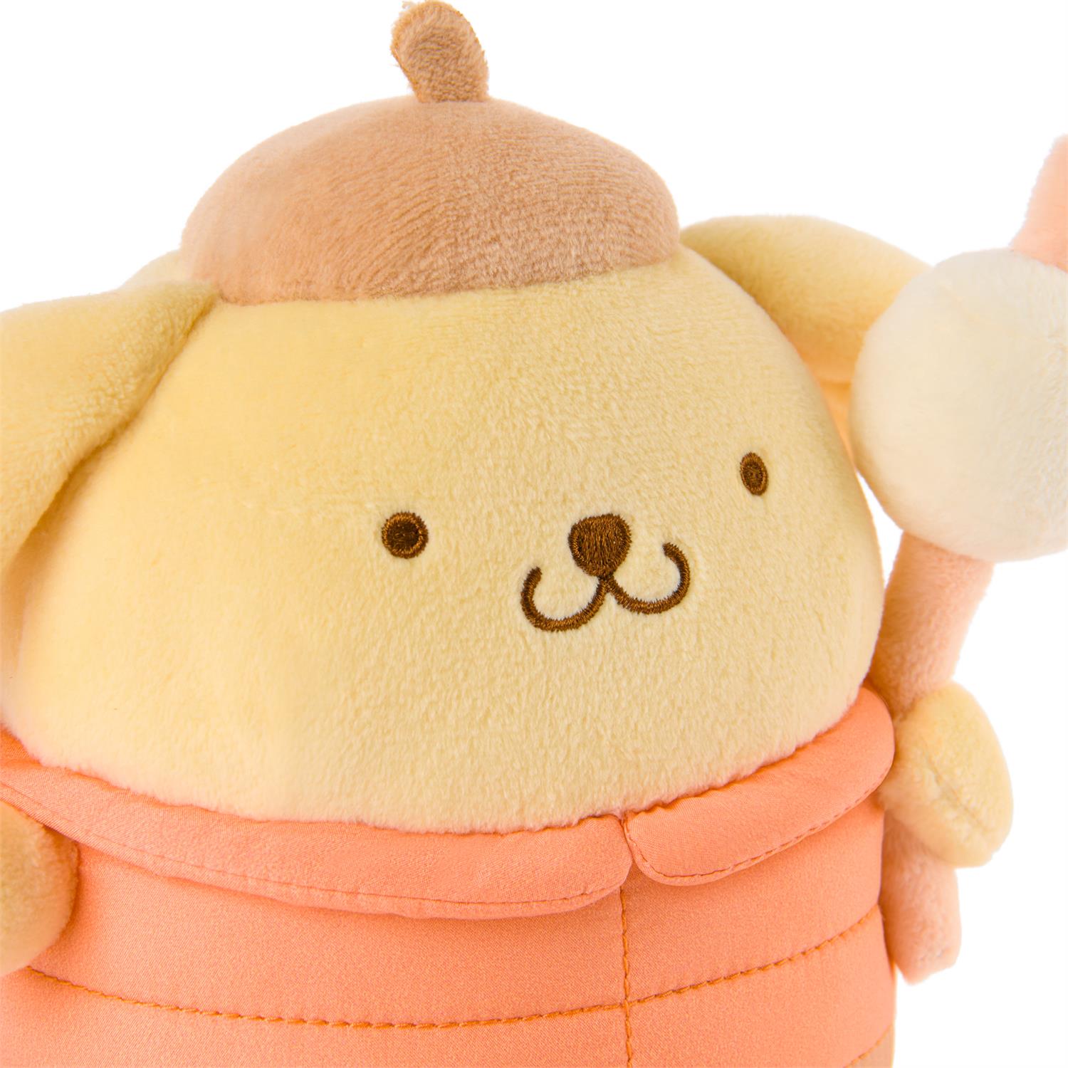 Cute plush toy with a round face and peach-colored outfit on a white background