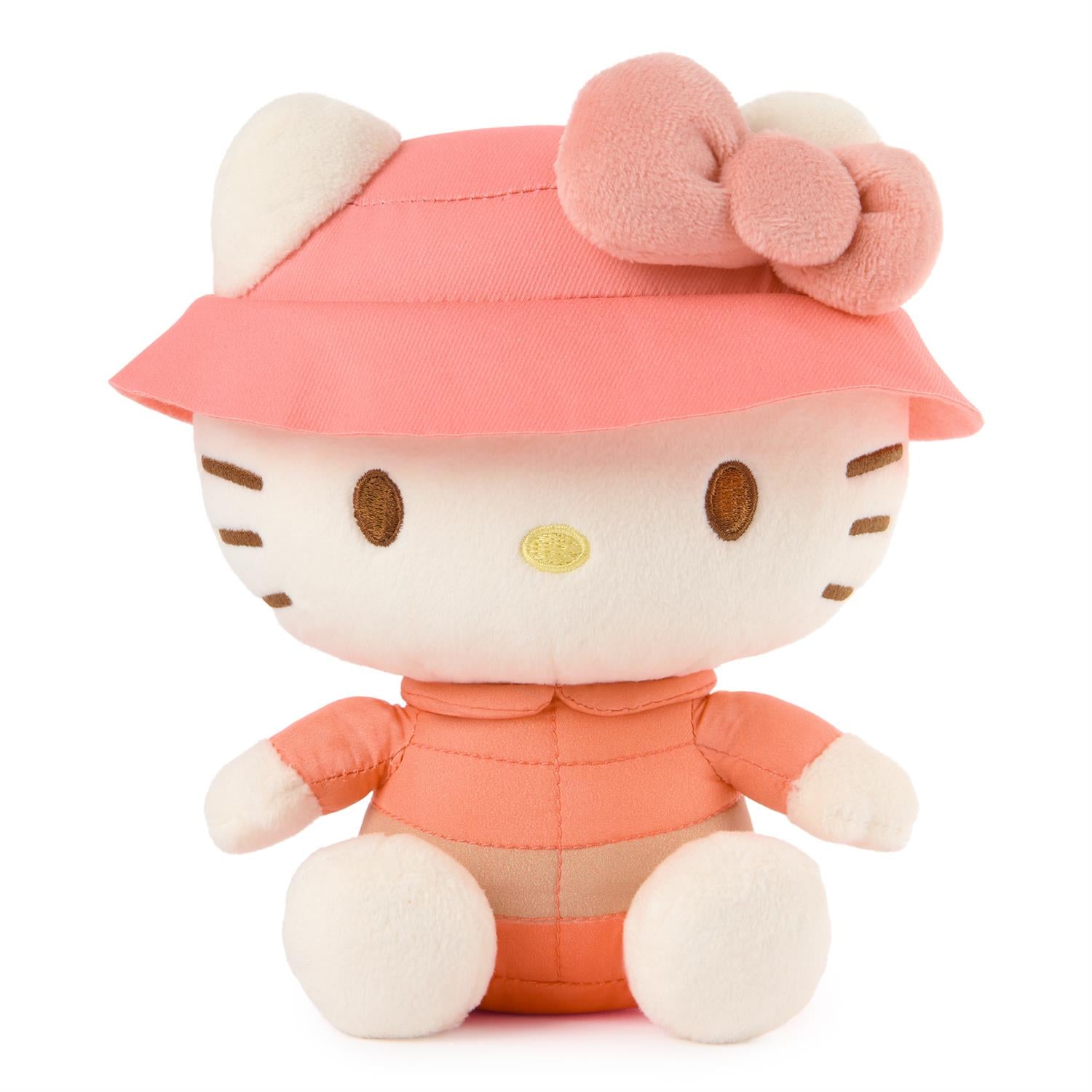 Plush toy resembling a character with a pink hat and dress on a white background