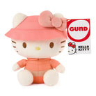 Plush toy Hello Kitty in peach outfit with pink bow, GUND tag on the side.