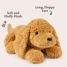 Brown plush dog toy with long, floppy ears on a light pink background