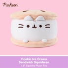 A Pusheen Cookie Ice Cream Sandwich Squisheen plush toy centered on a pink background, with a purple text banner at the bottom reading 'Cookie Ice Cream Sandwich Squisheen 11" Squishy Plush Toy.' The toy is white with beige cookie layers and small dark brown facial details.