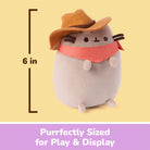 A Pusheen plush toy wearing an orange hat and pink bandana, shown on a pale yellow background with a height marker reading 6 in and a purple banner that says 'Purrfectly Sized for Play & Display'.