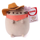 Plush toy resembling a cat in a cowboy hat and bandana with a GUND tag on a white background