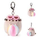 Two plush keychains of a cartoon cat character with sunglasses and a beach ball on a white background.