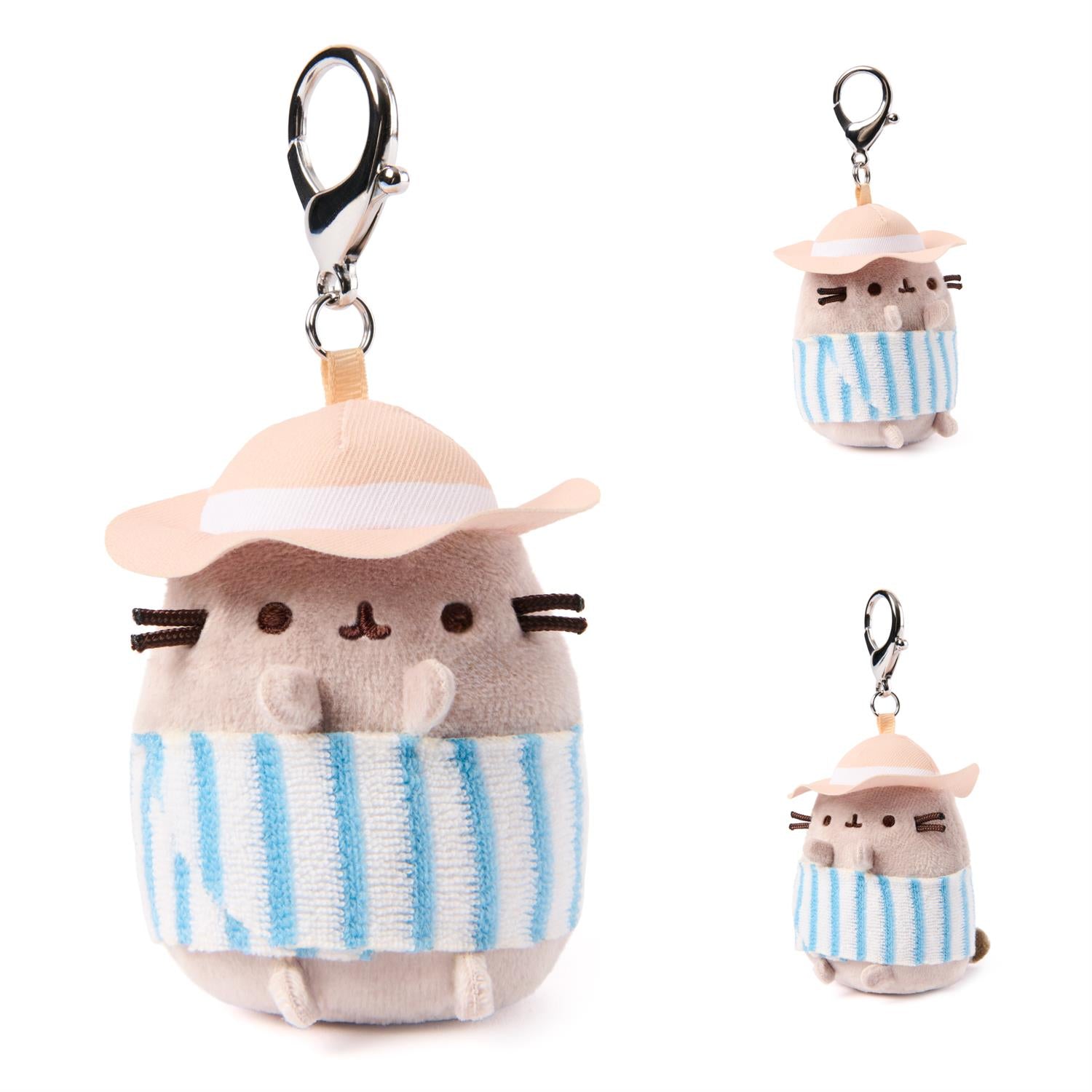Plush keychain of a cat character wearing a hat and striped towel on a white background