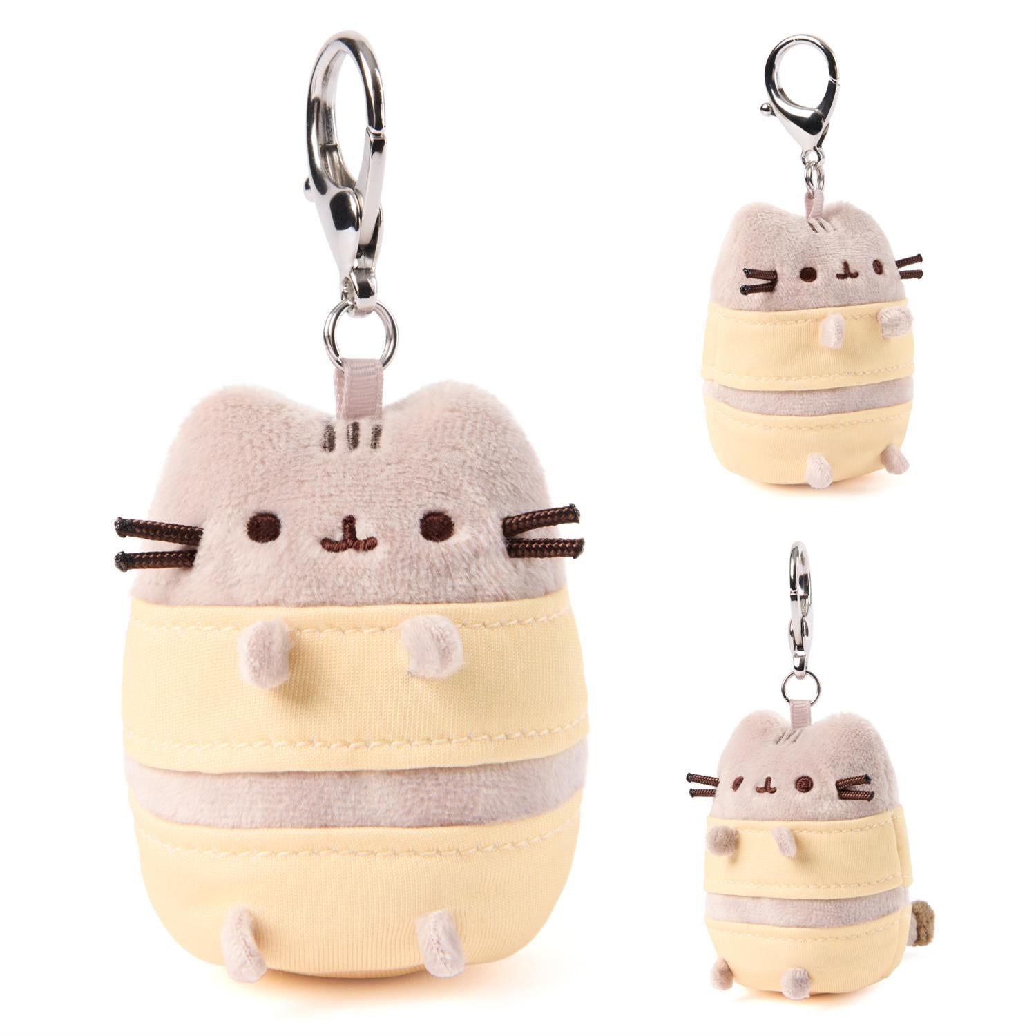 Plush keychain of a cartoon cat character in a yellow outfit with a white background