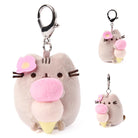 Plush keychain of a cartoon character with pink cheeks and flower accessories on a white background