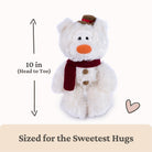 A white plush teddy bear wearing a dark red scarf and brown hat, shown on a light background with measurement text indicating 10 inches head to toe and the phrase 'Sized for the Sweetest Hugs'.