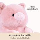 A close-up of a pink plush toy with soft faux suede ears and a black bead eye, on a white background with text reading 'Faux Suede Ears' and 'Ultra-Soft & Cuddly Surface-Washable Plush'.