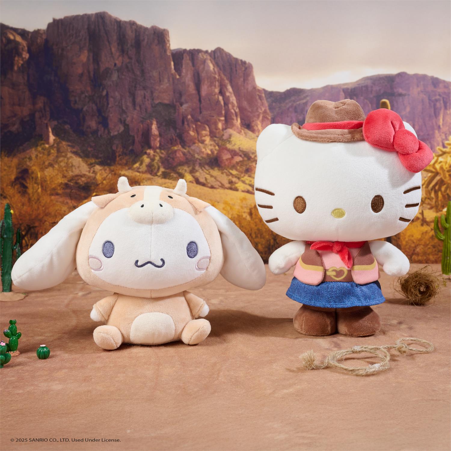 Two plush toys, one resembling a cow and the other a character with a cowboy hat and scarf, in a desert setting.